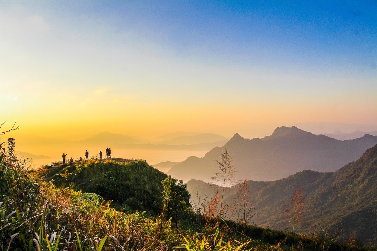Photo Of People Standing On Top Of Mountain Near Grasses 733162